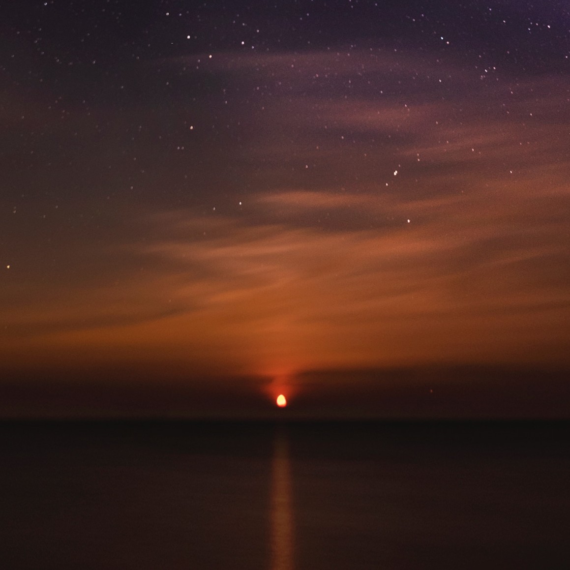 Starry sunset sky with warm orange and purple colors - symbolizing hope and new beginnings